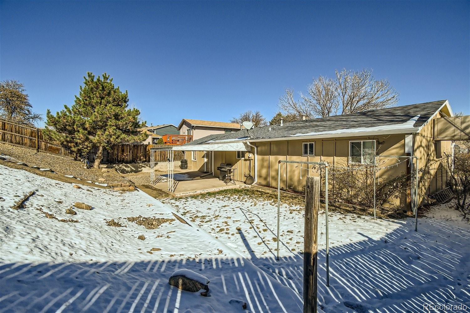 8207 High Street Denver, CO 80229 - Photo 11 of 11 a view of a house with wooden deck