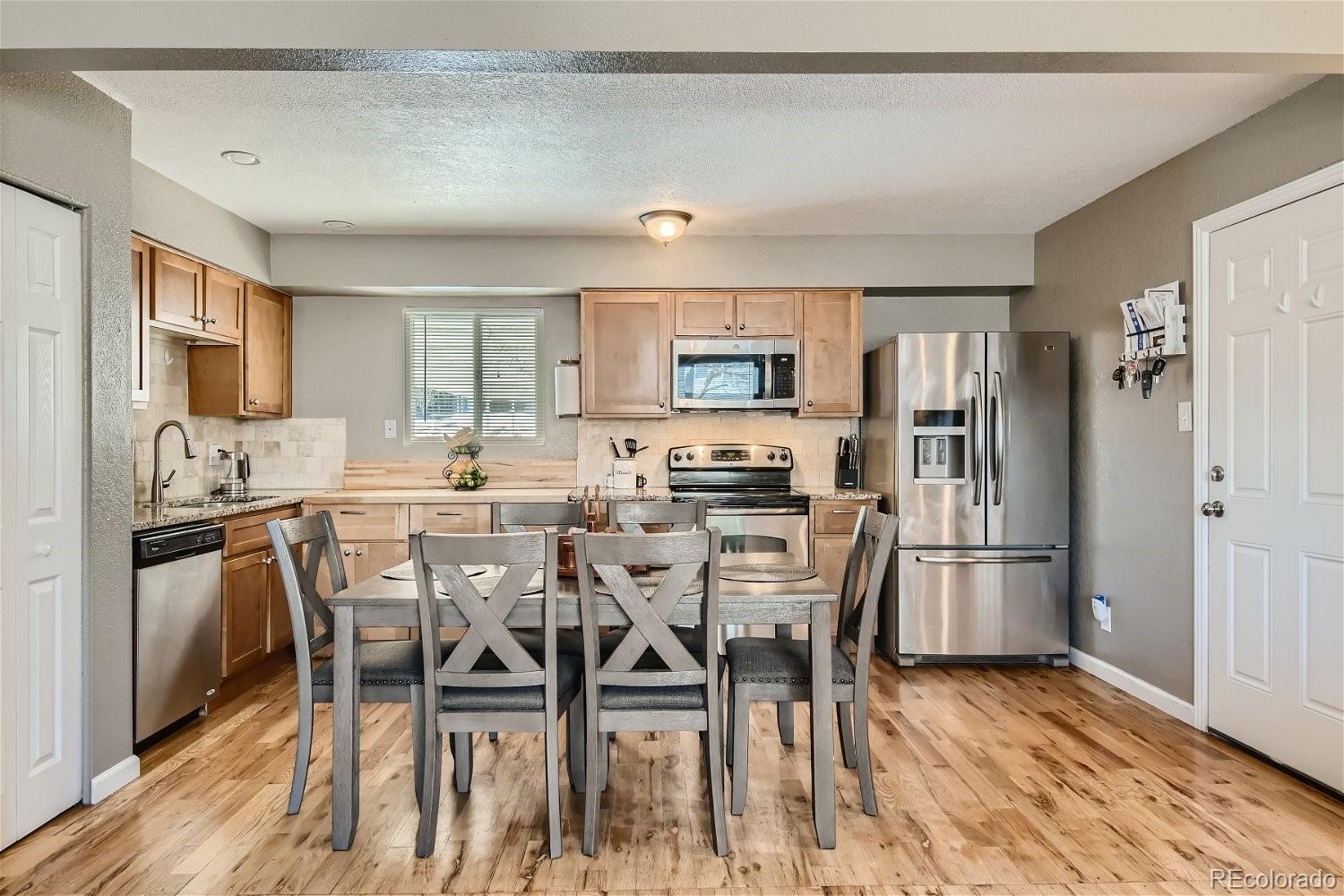 8207 High Street Denver, CO 80229 - Photo 4 of 11 a view of a dining room with furniture and wooden floor