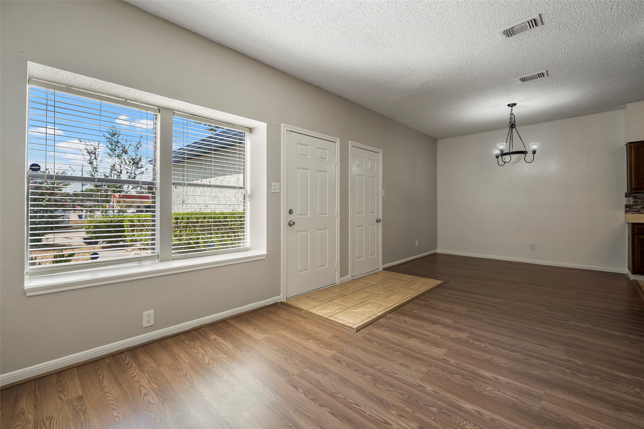 7120 Deer Creek Court Spring, TX 77379 - Photo 3 of 23 Living room with lot of natural light and laminate floors. The house has been recently painted.
