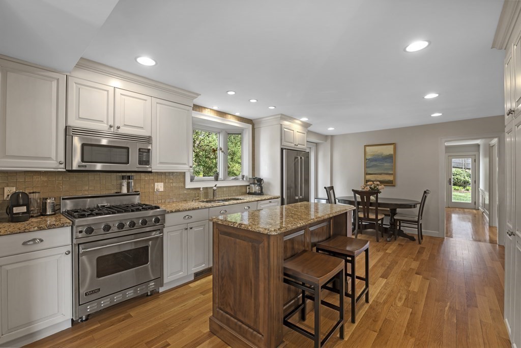 1 Wallingford Road Marblehead, MA 01945 - Photo 5 of 42 a kitchen with stainless steel appliances granite countertop wooden floors a stove and a refrigerator