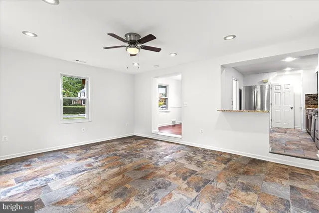 a view of a big room with wooden floor and windows