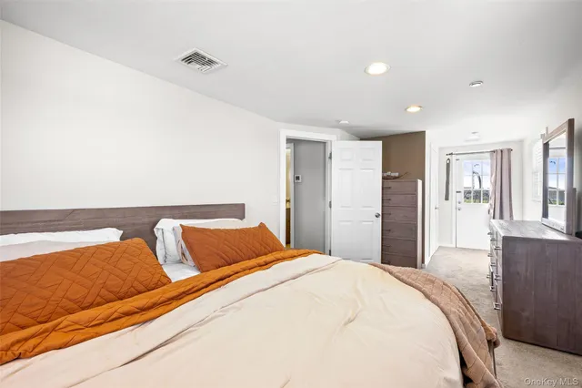 a bedroom with a bed and a couch