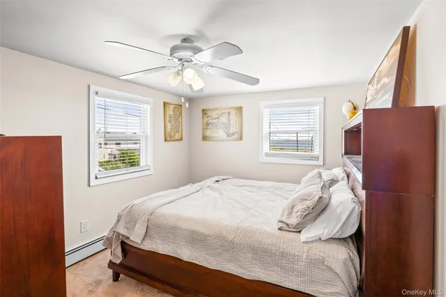 a bedroom with a bed dresser and a window