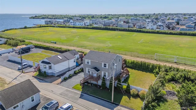 an aerial view of a house with a swimming pool patio and outdoor seating