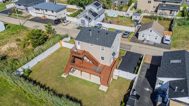 an aerial view of a house with outdoor space patio swimming pool and outdoor seating