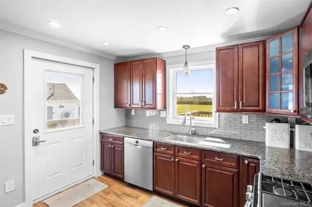 a kitchen with stainless steel appliances granite countertop a sink stove and cabinets