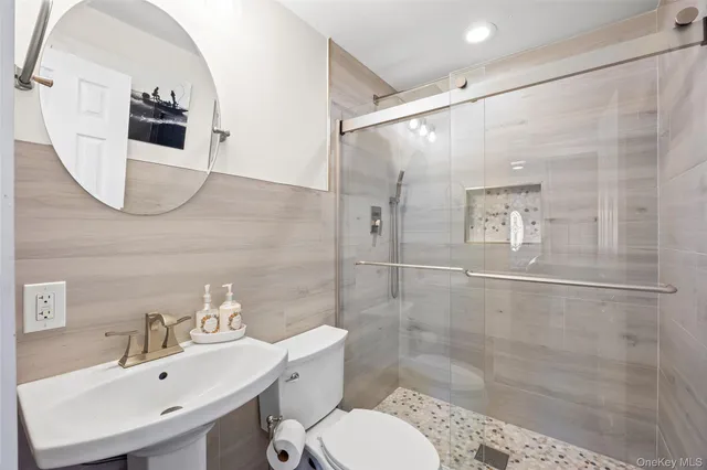a bathroom with a sink toilet and shower
