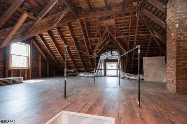 a view of a room with wooden floor and windows