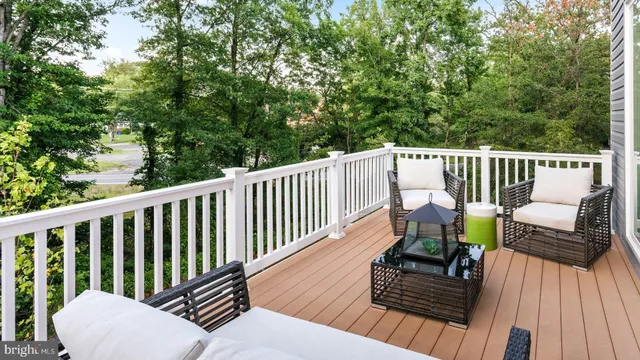a view of balcony with wooden floor and outdoor seating