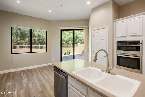 a kitchen with a sink a stove and a microwave