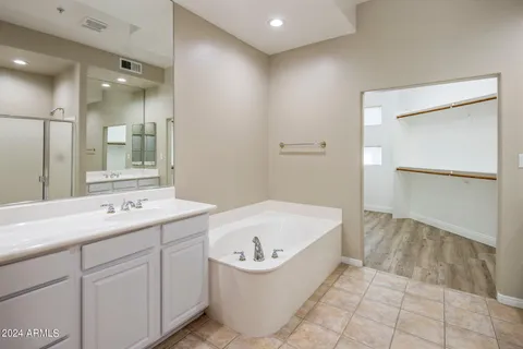 a bathroom with a bathtub sink and mirror