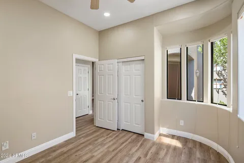 a view of a room with wooden floor and natural light