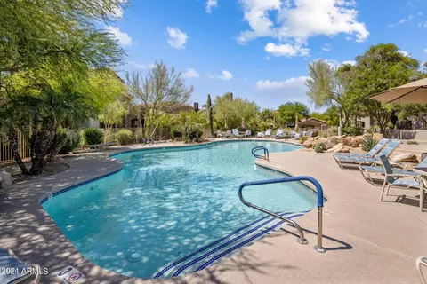 a swimming pool with outdoor seating and yard