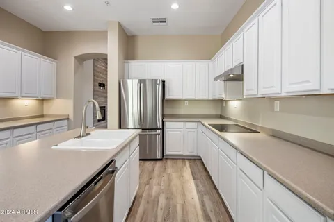 a kitchen with a sink stove and refrigerator