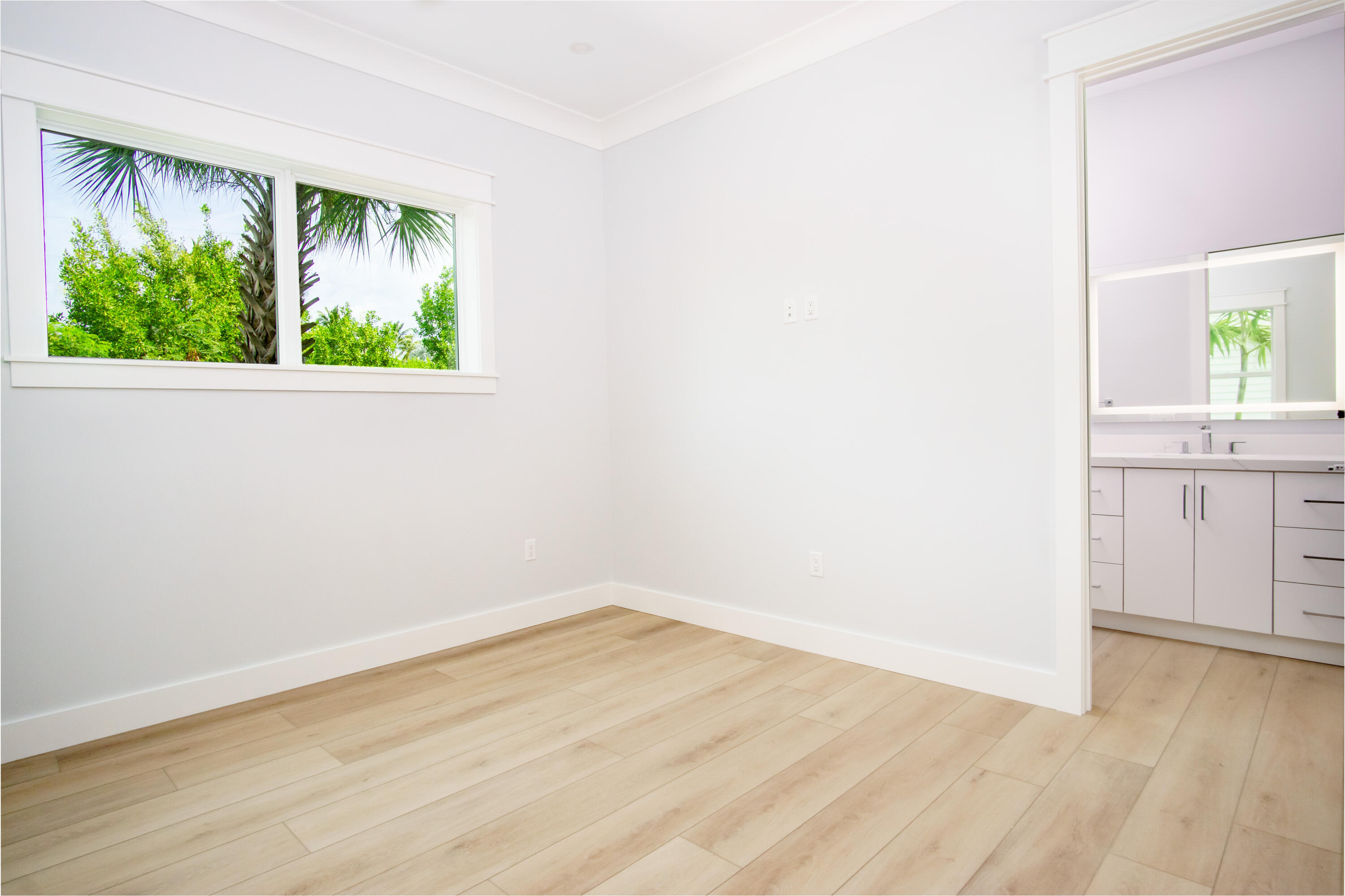105 Carroll Street, Unit 6 Islamorada, FL 33036 - Photo 20 of 31 an empty room with wooden floor and windows