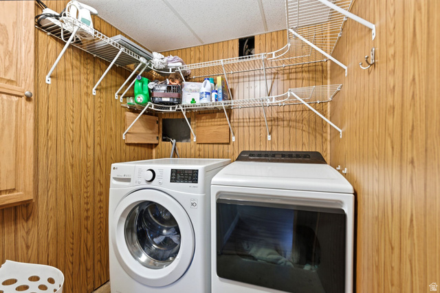 935 900 North Bountiful, UT 84010 - Photo 26 of 46 Laundry area featuring wood walls, washing machine and clothes dryer, and a paneled ceiling