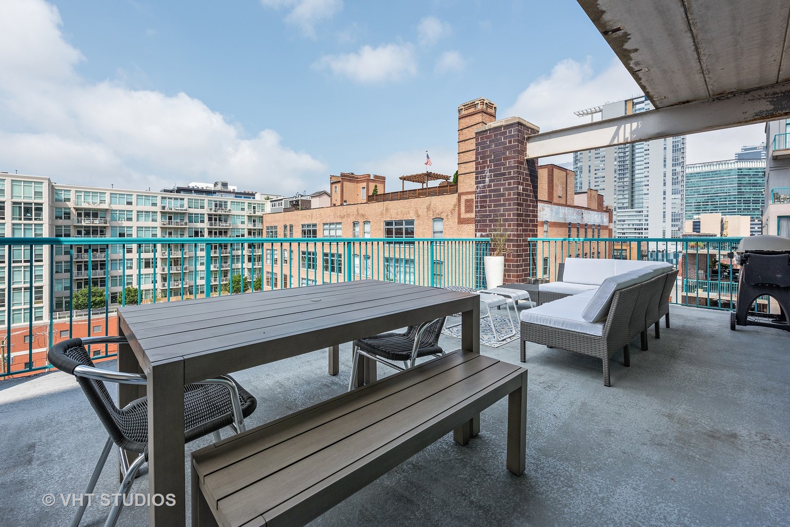 920 West Madison Street, Unit F8 Chicago, IL 60607 - Photo 13 of 14 a roof deck with outdoor seating and city view