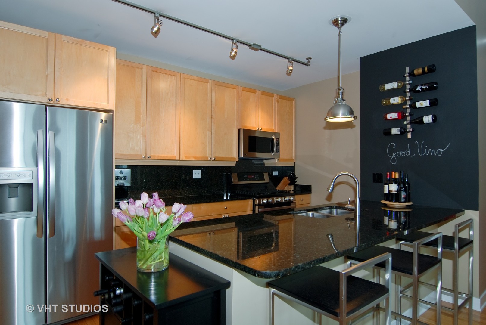 920 West Madison Street, Unit F8 Chicago, IL 60607 - Photo 4 of 14 a kitchen with stainless steel appliances granite countertop a refrigerator a sink a stove white cabinets and wooden floor