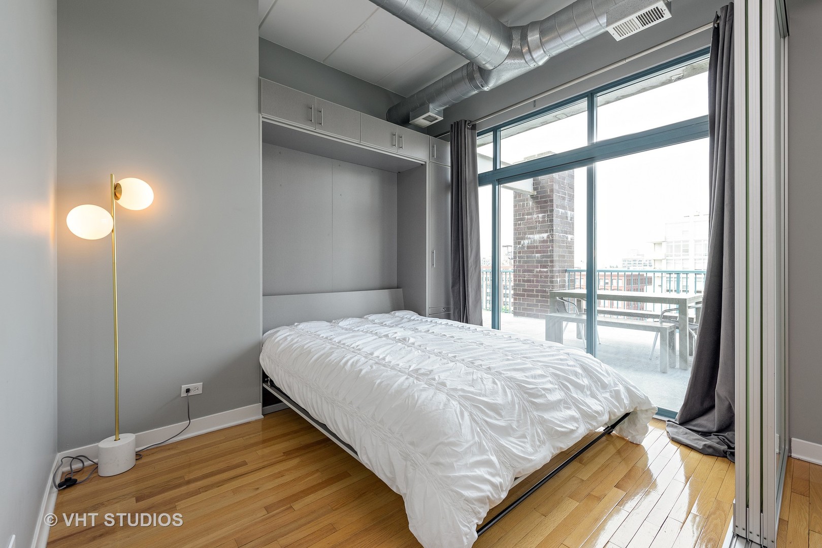 920 West Madison Street, Unit F8 Chicago, IL 60607 - Photo 8 of 14 a bedroom with a bed and a large window