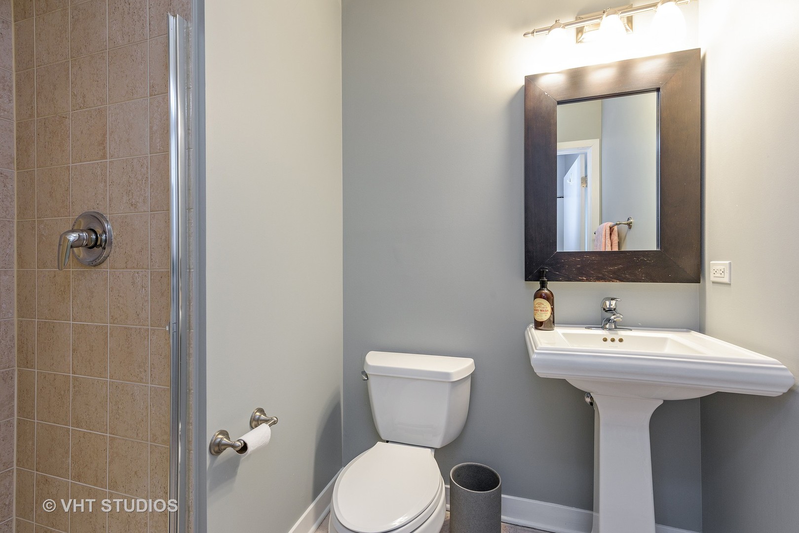 920 West Madison Street, Unit F8 Chicago, IL 60607 - Photo 9 of 14 a bathroom with a toilet sink and mirror