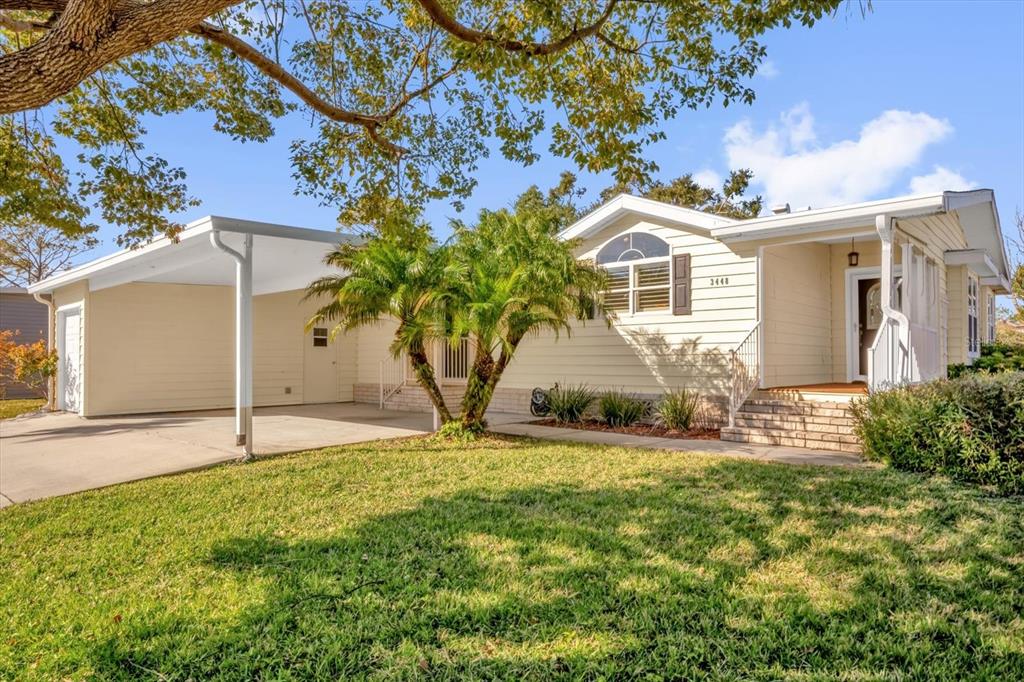 a white house that has a tree in front of it