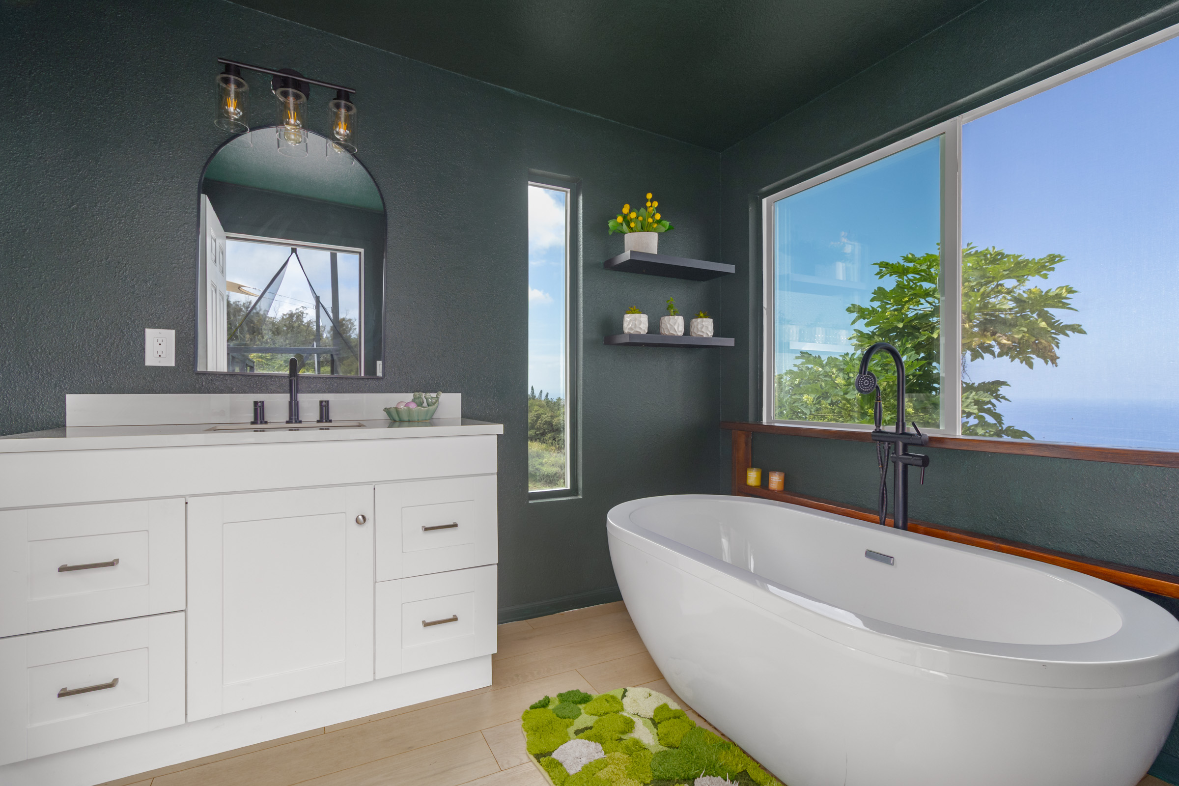 87-2793 Hawaii Belt Road Captain Cook, HI 96704 - Photo 20 of 30 a bathroom with a bathtub sink and mirror