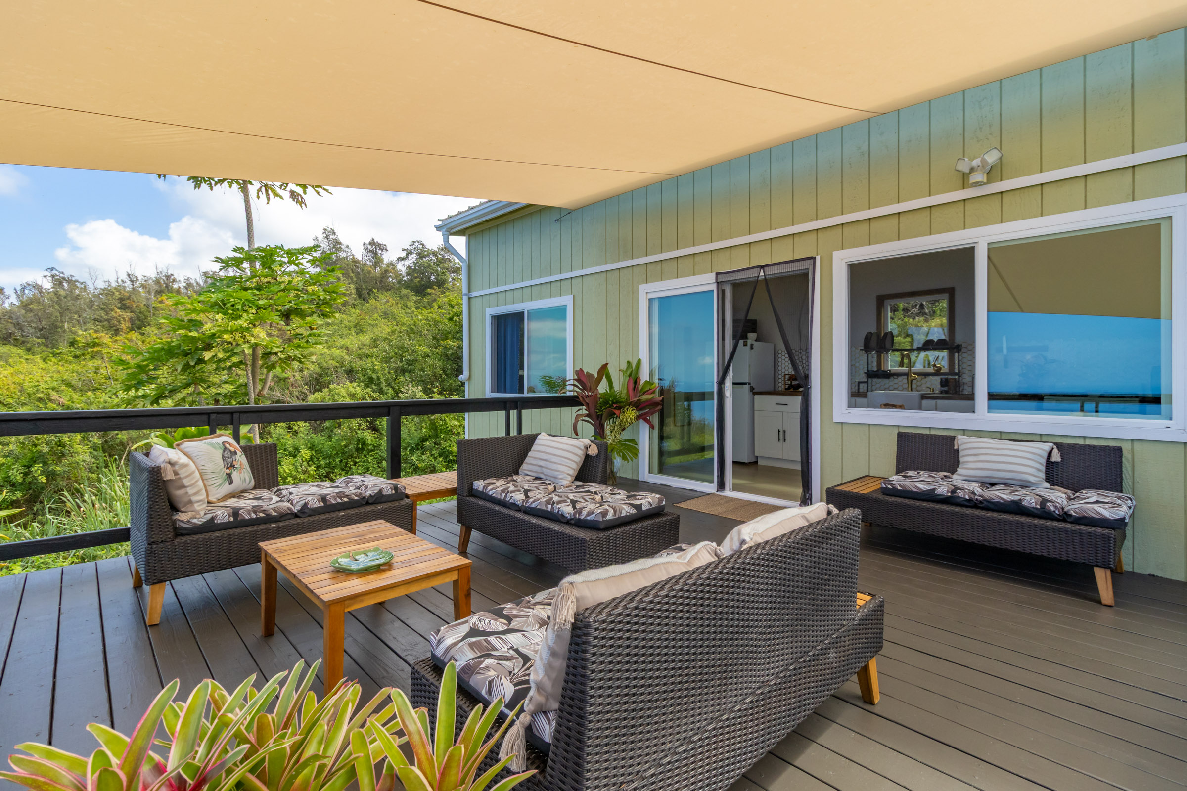 87-2793 Hawaii Belt Road Captain Cook, HI 96704 - Photo 5 of 30 a balcony with furniture and a wooden floor