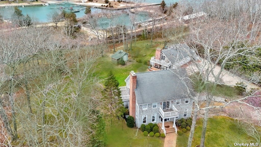 a aerial view of a house with a yard and lake view
