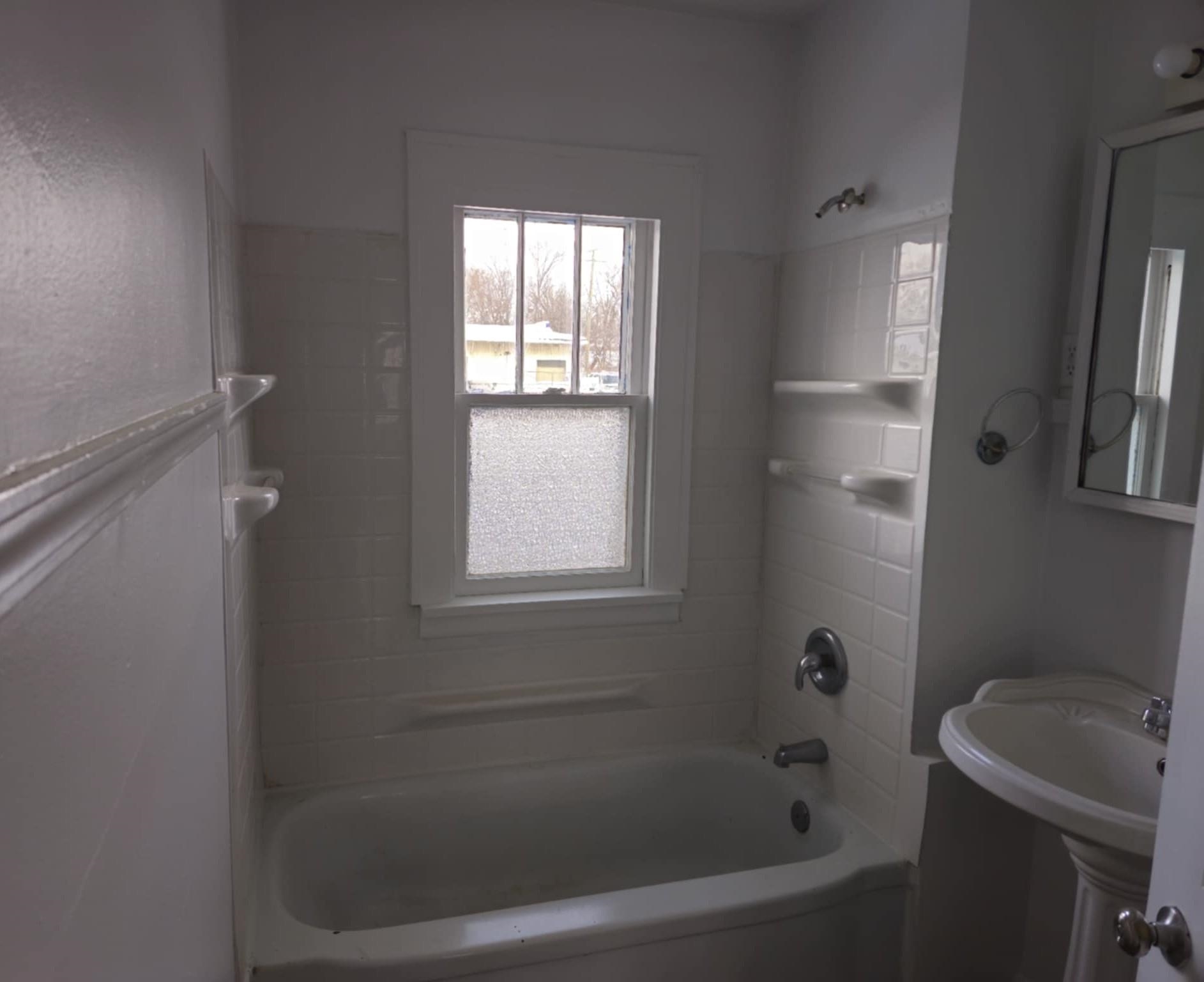 1519 15th Street Rockford, IL 61104 - Photo 5 of 11 a bathroom with a bathtub toilet and window
