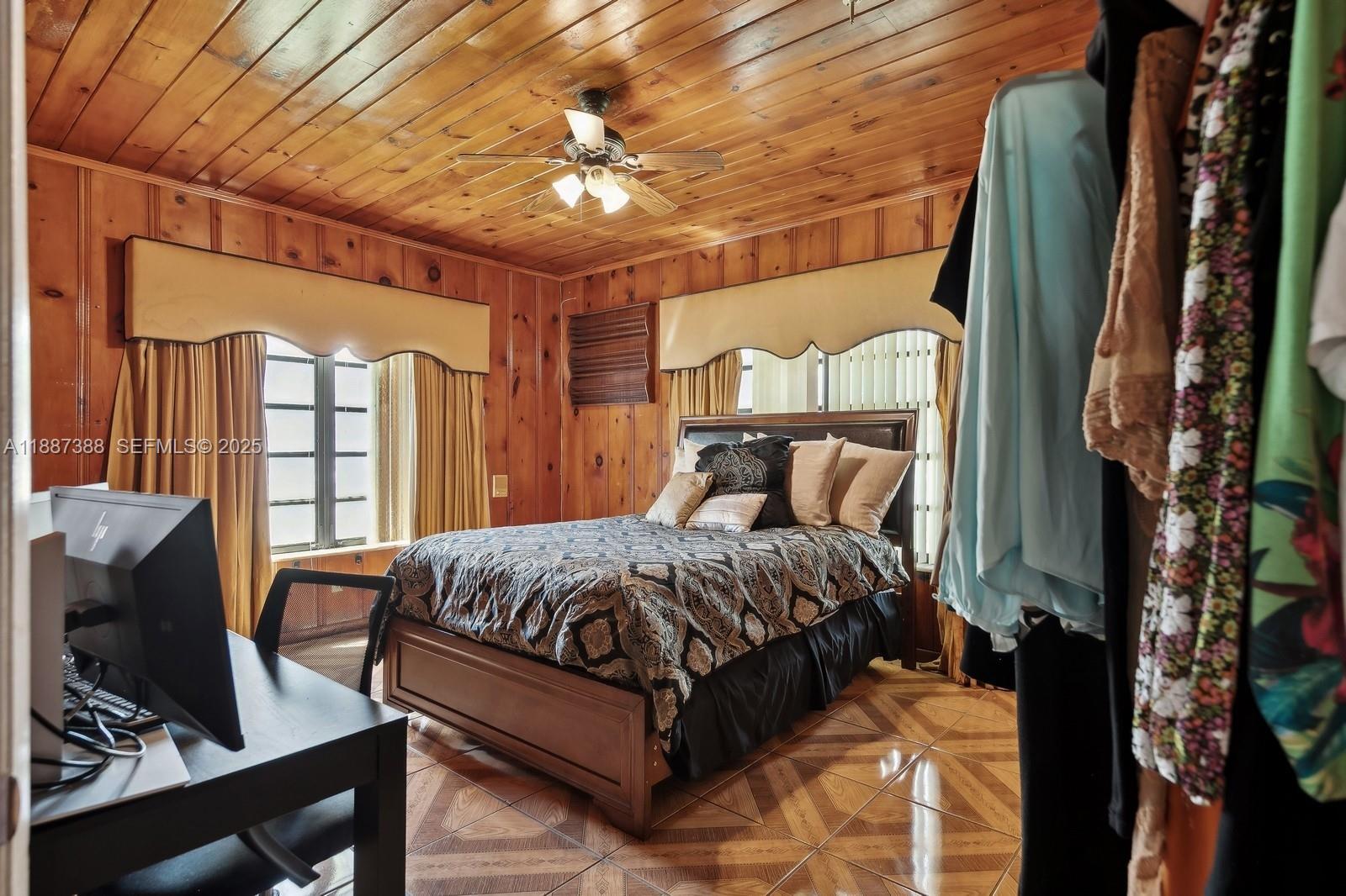 469 Northwest 69th Street Miami, FL 33150 - Photo 15 of 39 a bedroom with a bed couch and a window