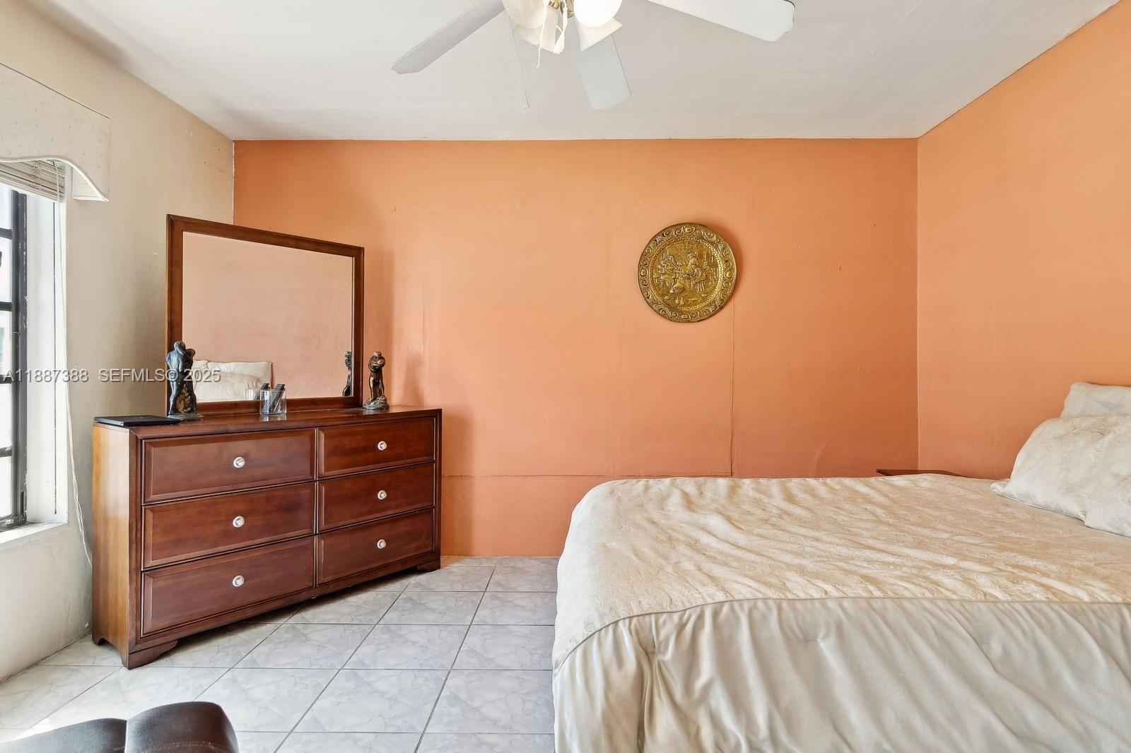 469 Northwest 69th Street Miami, FL 33150 - Photo 18 of 39 a bedroom with a bed and a dresser