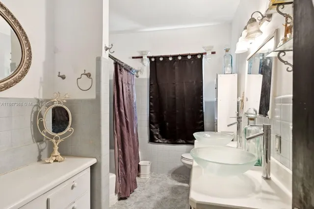 a bathroom with a toilet sink and mirror