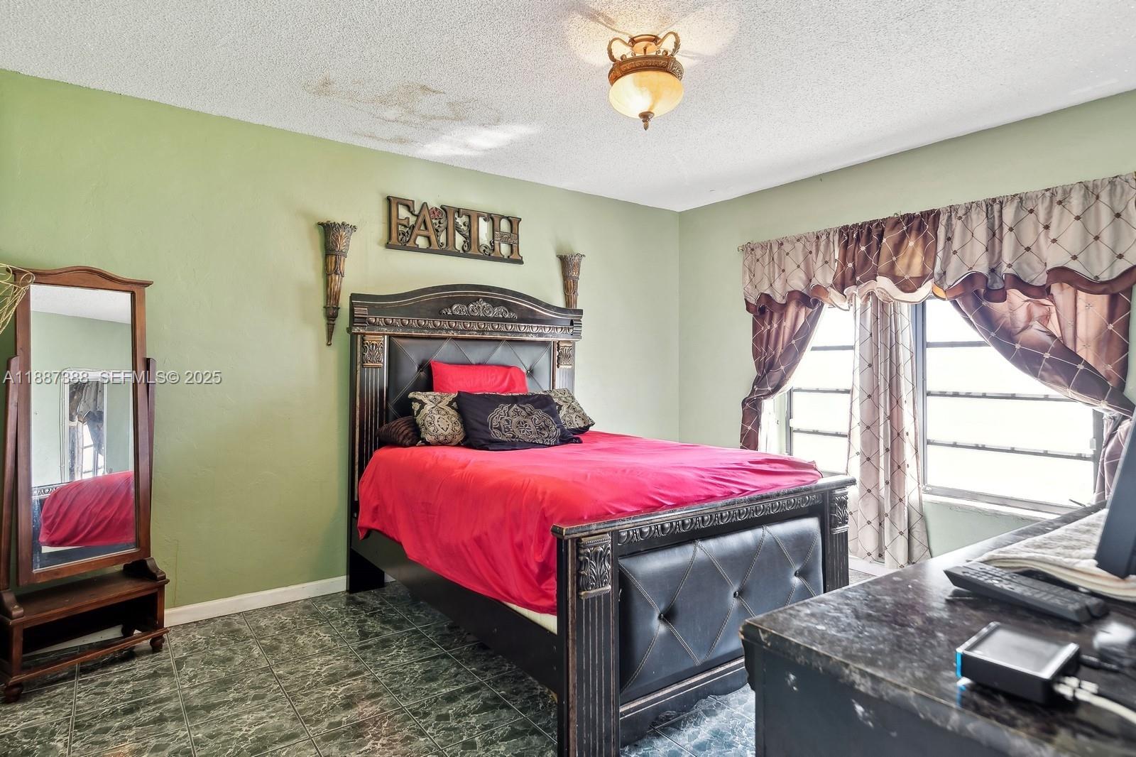 469 Northwest 69th Street Miami, FL 33150 - Photo 21 of 39 a bedroom with a bed and a window