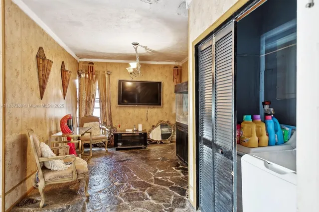 a living room filled with furniture and a flat screen tv
