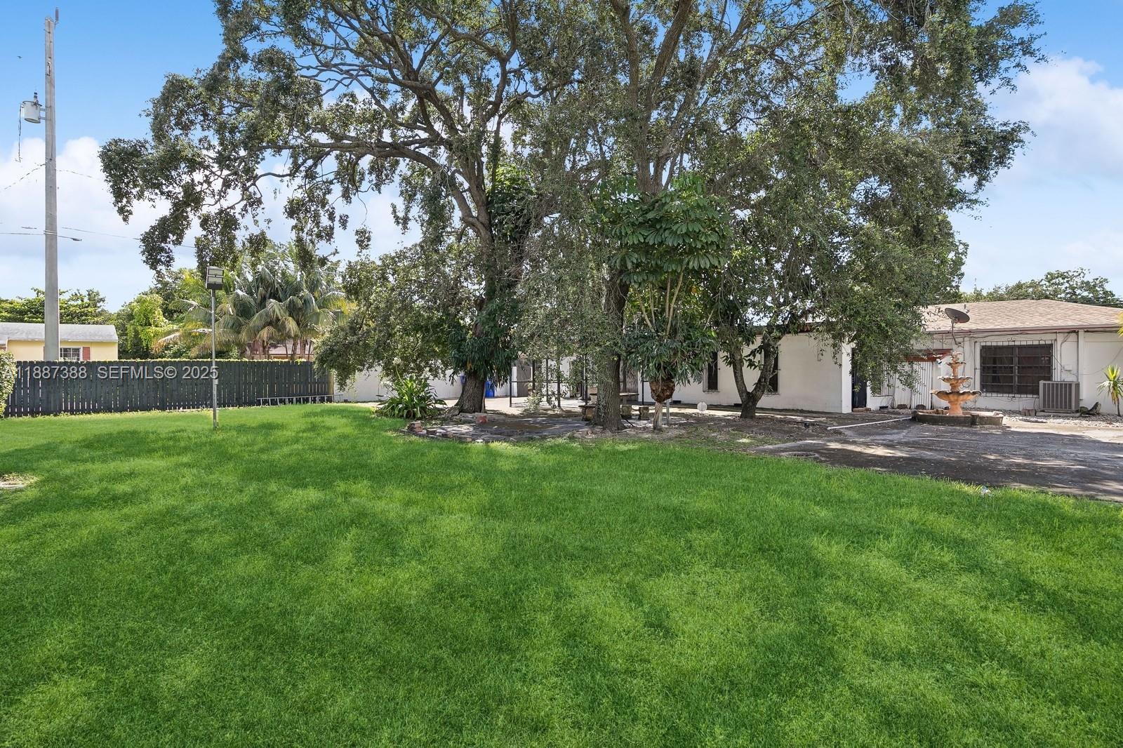 469 Northwest 69th Street Miami, FL 33150 - Photo 24 of 39 a view of a house with backyard and a tree