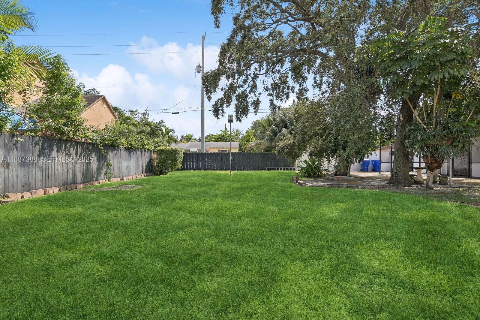 469 Northwest 69th Street Miami, FL 33150 - Photo 25 of 39 a green field with lots of trees in the background