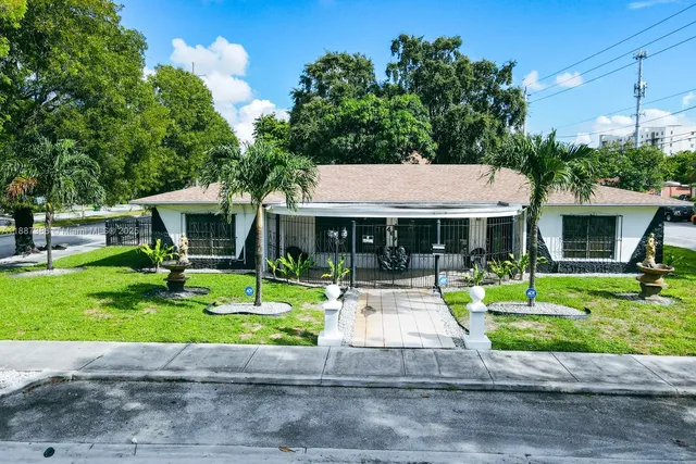 a front view of a house with a yard table and chairs
