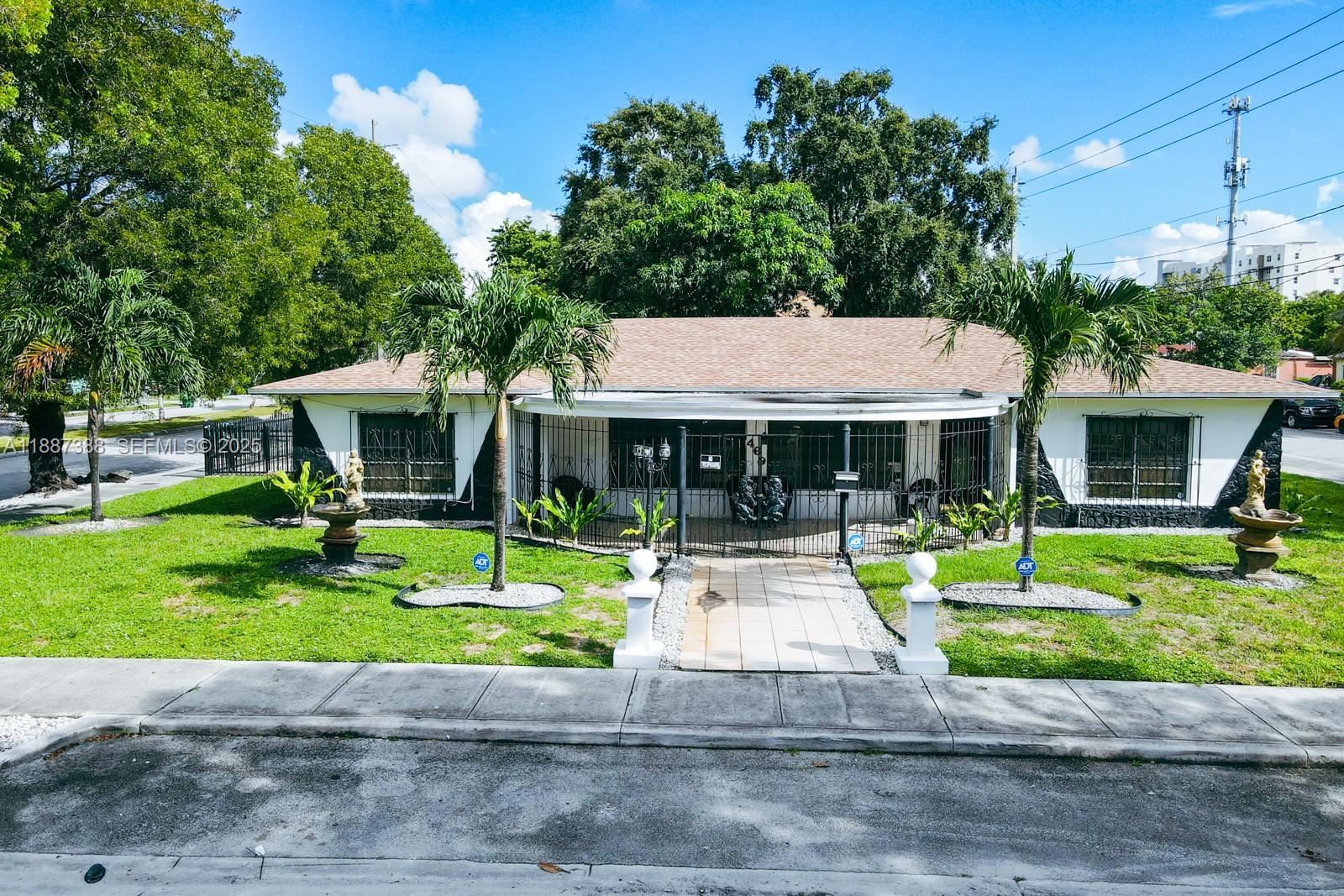 469 Northwest 69th Street Miami, FL 33150 - Photo 27 of 39 a front view of a house with a yard table and chairs