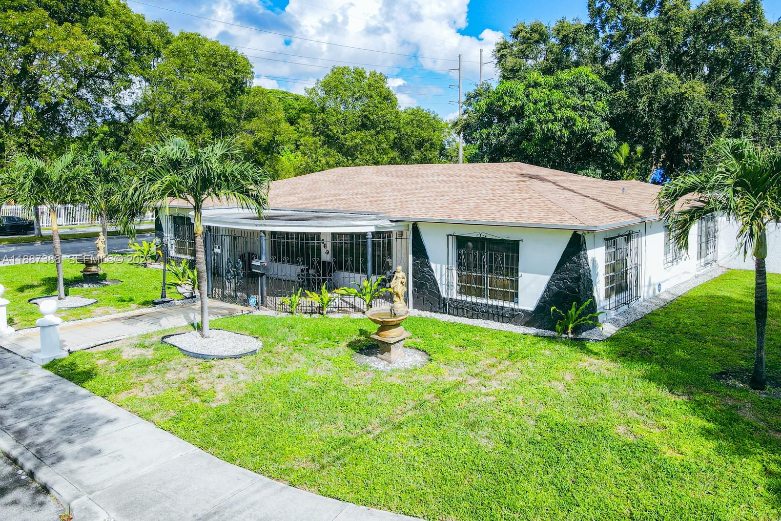 469 Northwest 69th Street Miami, FL 33150 - Photo 28 of 39 a front view of a house with a yard table and chairs