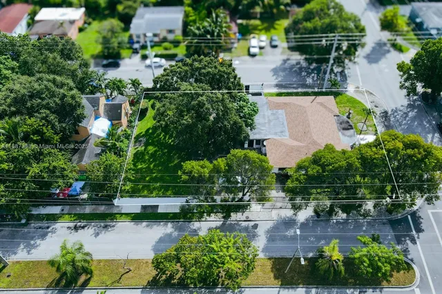 an aerial view of a house with a yard and lake view