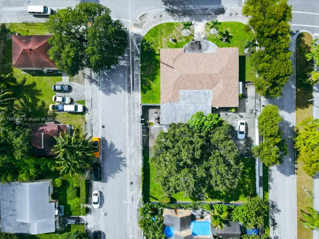 an aerial view of a house with a yard and garden