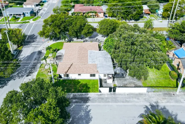 an aerial view of a house with a garden and plants