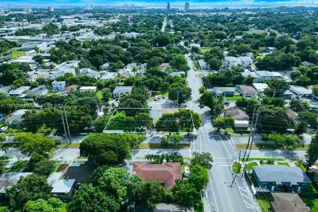 an aerial view of a houses with a yard