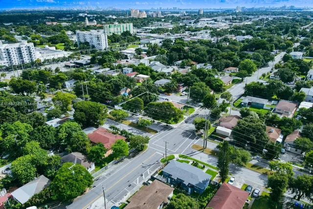 an aerial view of a houses with a yard