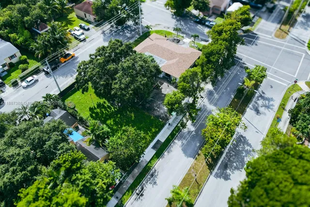 an aerial view of a house with a yard