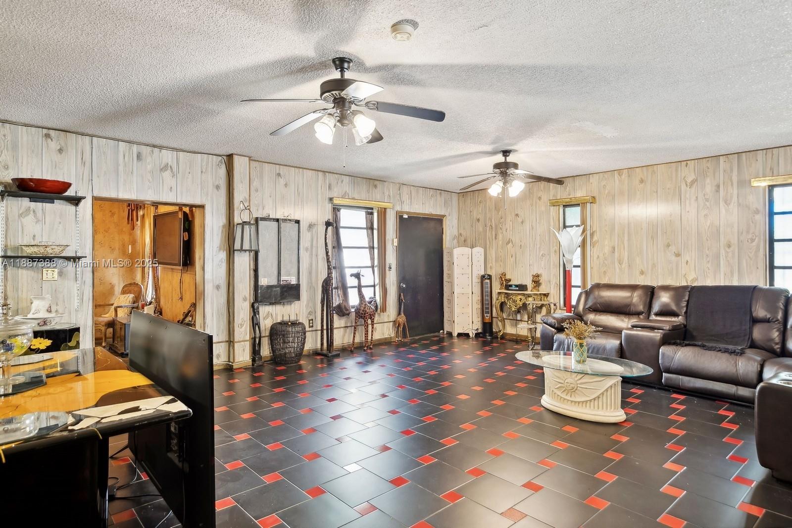 469 Northwest 69th Street Miami, FL 33150 - Photo 9 of 39 a living room with furniture and a flat screen tv