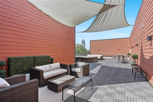 a view of a patio with couches and table and chairs with wooden floor