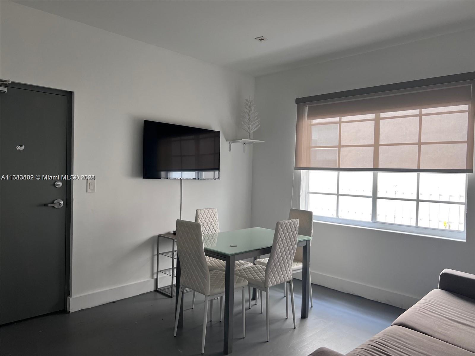 600 15th Street, Unit 4 Miami Beach, FL 33139 - Photo 3 of 15 a view of a livingroom with furniture and a flat screen tv