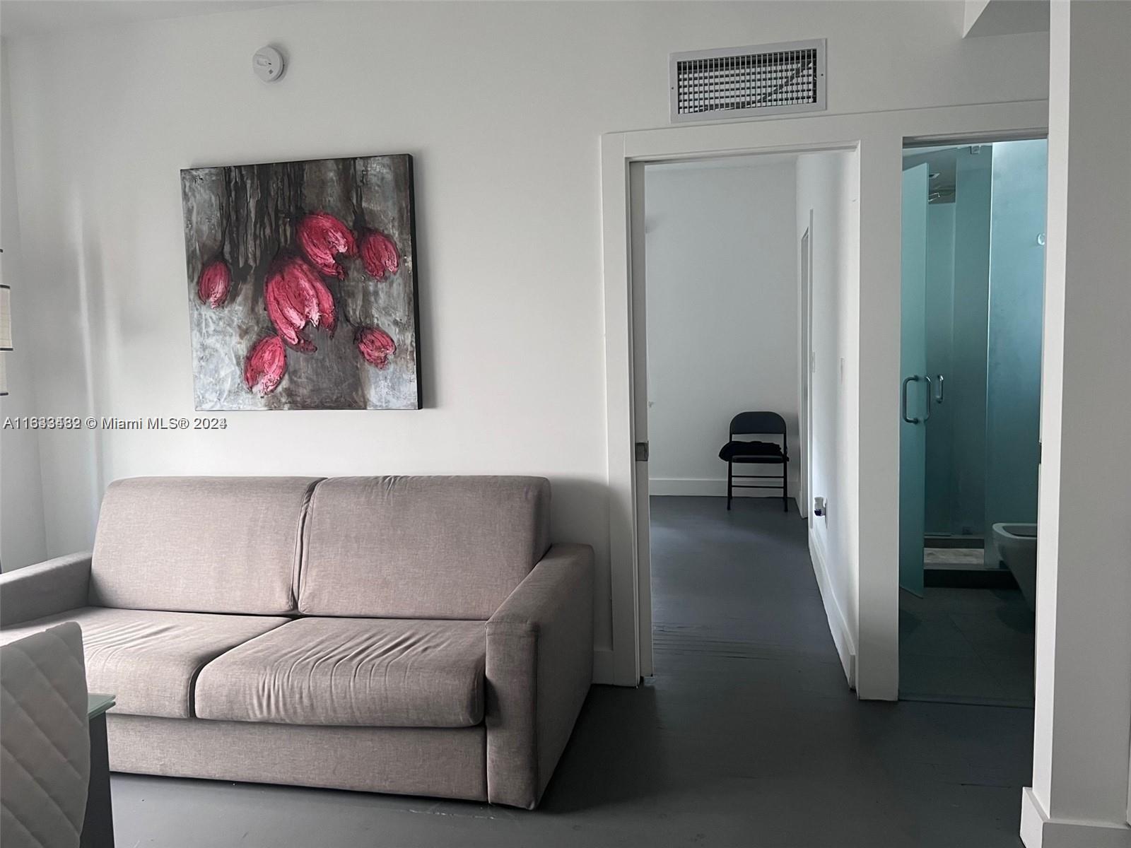 600 15th Street, Unit 4 Miami Beach, FL 33139 - Photo 4 of 15 a living room with furniture and a walk in closet