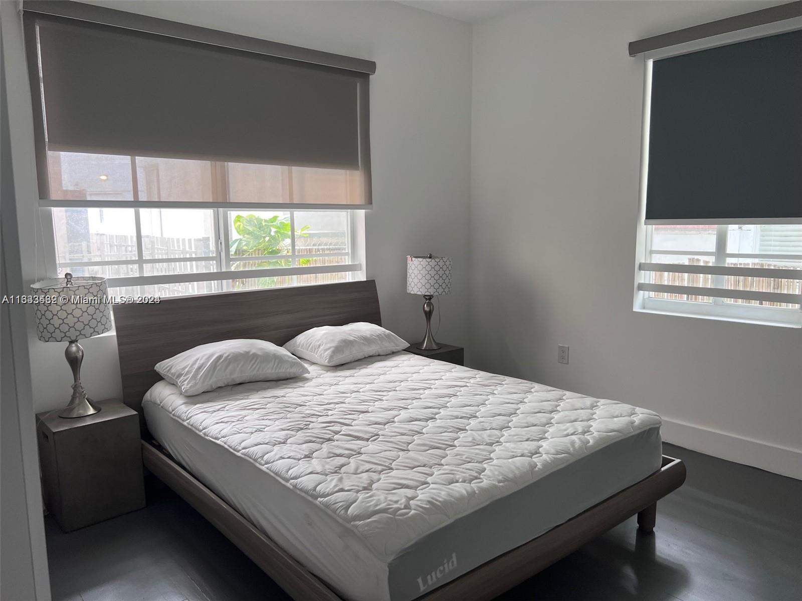 600 15th Street, Unit 4 Miami Beach, FL 33139 - Photo 6 of 15 a bed sitting in a bedroom next to a window